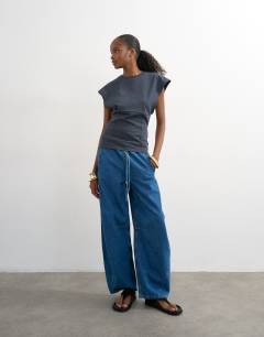 Model wearing Clean corset seamed cap sleeve top in charcoal