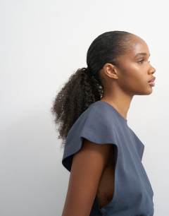 Model wearing Clean corset seamed cap sleeve top in charcoal