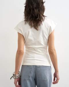 Model wearing Clean corset seamed cap sleeve top in ivory