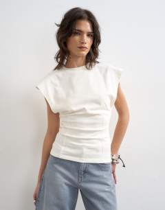 Model wearing Clean corset seamed cap sleeve top in ivory