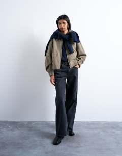 Model wearing Clean cropped quilted lined bomber with wool in taupe
