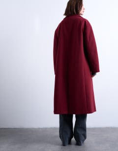 Model wearing Clean double breasted longline coat in burgundy