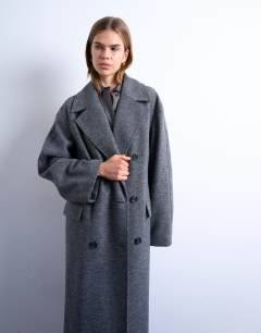 Model wearing Clean double breasted longline coat in charcoal