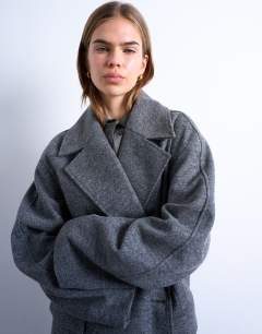 Model wearing Clean double breasted longline coat in charcoal