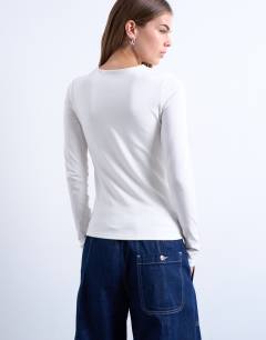 Model wearing Clean long sleeve top in ivory