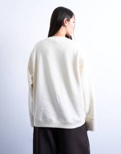 Model wearing Clean oversized deep cuff sweat in ecru
