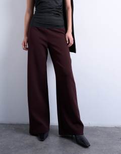 Model wearing Clean pull on tailored trouser in burgundy