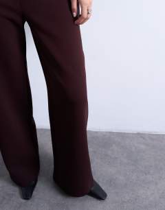 Model wearing Clean pull on tailored trouser in burgundy