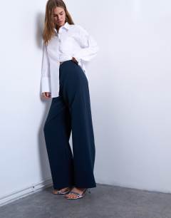 Model wearing Clean pull on tailored trouser in navy 