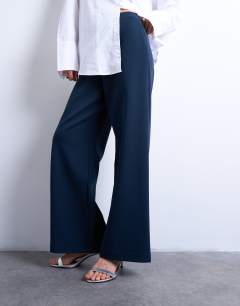Model wearing Clean pull on tailored trouser in navy 