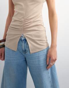 Model wearing Clean ruched tank in oat