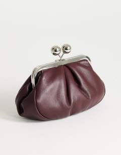 Model wearing Clover small clutch bag in aubergine