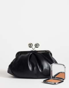Model wearing Clover small clutch bag in black in black