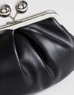 Model wearing Clover small clutch bag in black in black