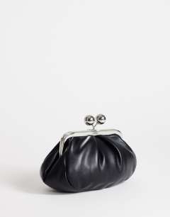 Model wearing Clover small clutch bag in black in black