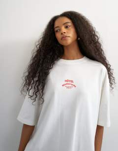 Model wearing Topshop 'Club Med' graphic oversized t-shirt in white