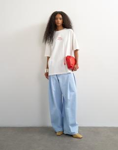 Model wearing Topshop 'Club Med' graphic oversized t-shirt in white