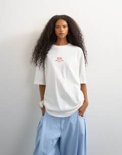 Model wearing Topshop 'Club Med' graphic oversized t-shirt in white