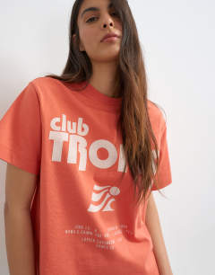 Model wearing Club Tropic graphic boxy tee in red