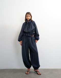 Model wearing Co ord balloon trouser with tie waist in navy