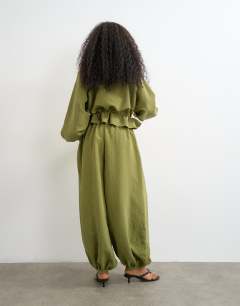 Model wearing Co ord balloon trouser with tie waist in olive