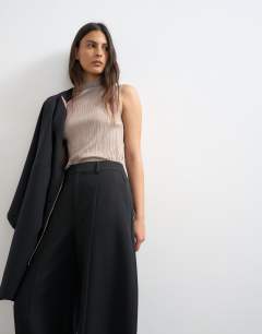 Model wearing Co ord barrel leg trouser in black 