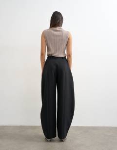 Model wearing Co ord barrel leg trouser in black 