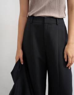 Model wearing Co ord barrel leg trouser in black 