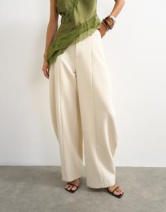 Model wearing Co ord barrel leg trouser in ecru