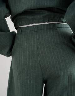 Model wearing Co ord barrel trouser in green stripe