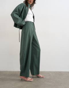 Model wearing Co ord barrel trouser in green stripe