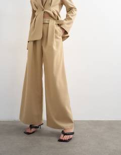 Model wearing Co ord belted highwaisted double pleat trouser in beige