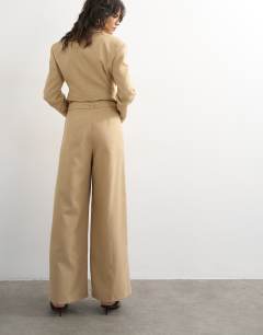 Model wearing Co ord belted highwaisted double pleat trouser in beige