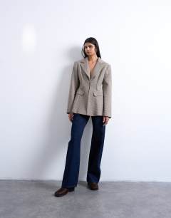 Model wearing Co ord  check cinched waist blazer in brown