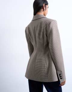 Model wearing Co ord  check cinched waist blazer in brown