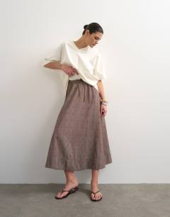 Model wearing Co ord check tie waist pleated maxi skirt in brown
