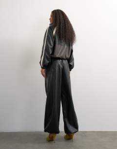 Model wearing Co-ord colour block faux leather joggers