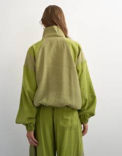 Model wearing Co ord colour block funnel neck track jacket in green
