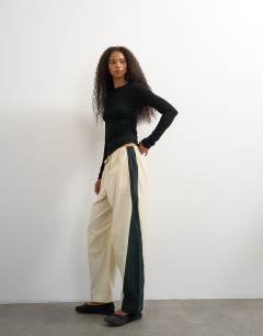 Model wearing Co ord colour block techy trouser in stone and black