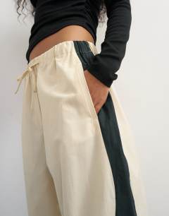 Model wearing Co ord colour block techy trouser in stone and black