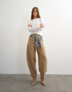 Model wearing Co ord contrast check wrap barrel trouser in brown 