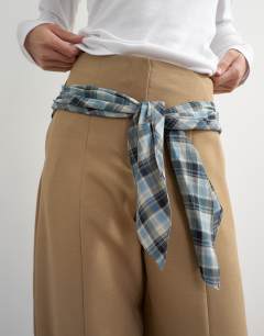 Model wearing Co ord contrast check wrap barrel trouser in brown 