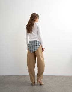 Model wearing Co ord contrast check wrap barrel trouser in brown 