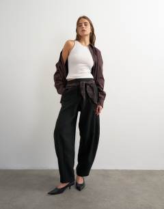 Model wearing Co ord contrast check wrap barrel trouser in brown