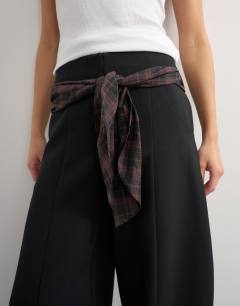 Model wearing Co ord contrast check wrap barrel trouser in brown
