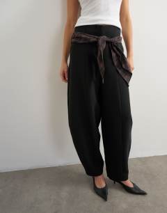 Model wearing Co ord contrast check wrap barrel trouser in brown