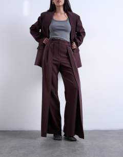 Model wearing Co ord double pleated straight leg trouser in plum chocolate