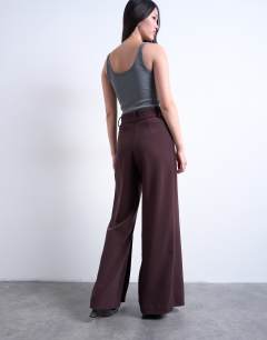 Model wearing Co ord double pleated straight leg trouser in plum chocolate