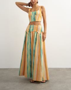 Model wearing Co-ord drop waist full circle midi skirt in orange abstract stripe