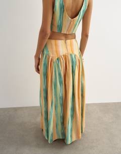 Model wearing Co-ord drop waist full circle midi skirt in orange abstract stripe